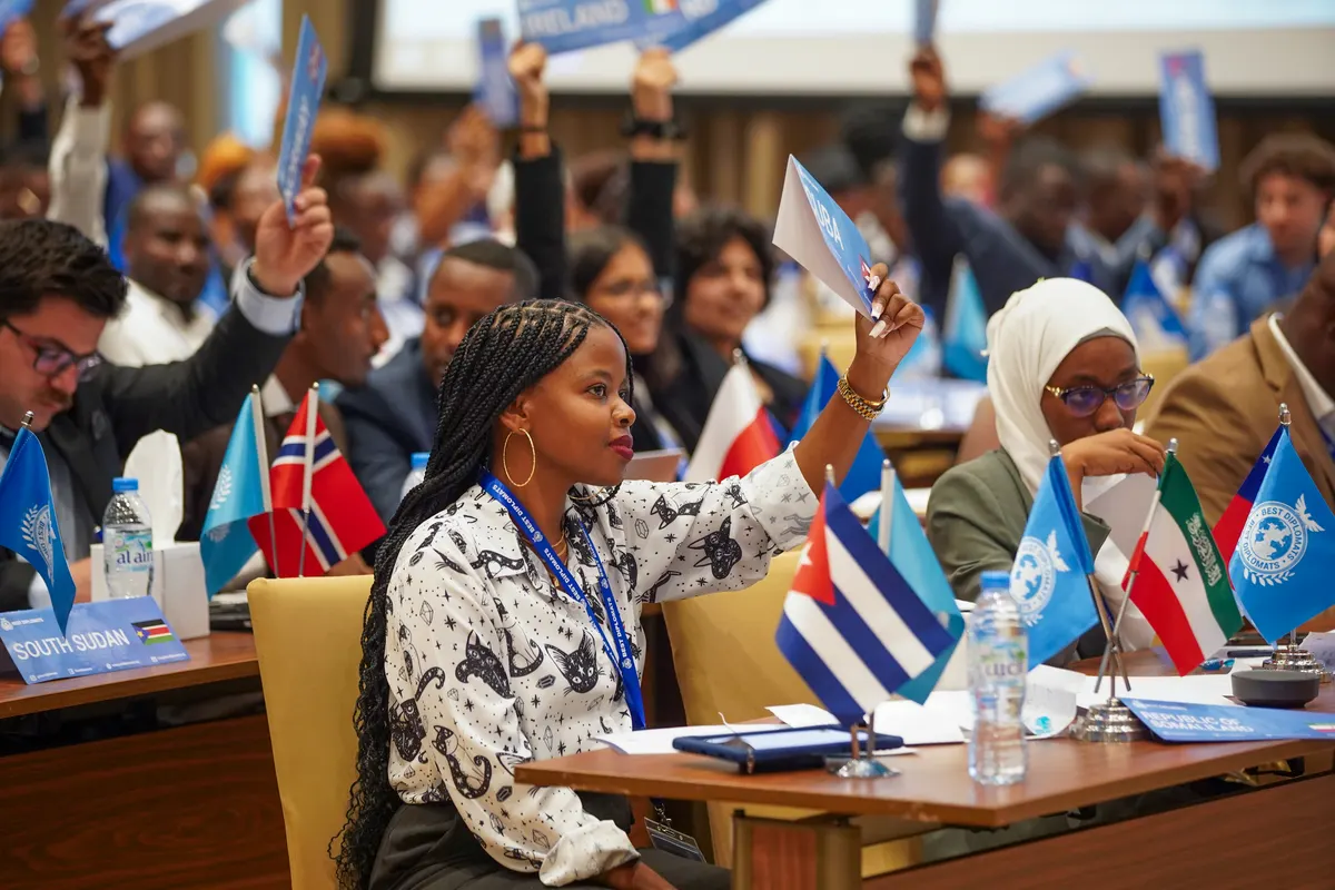 A delegate raises her placard in committee, Dubai